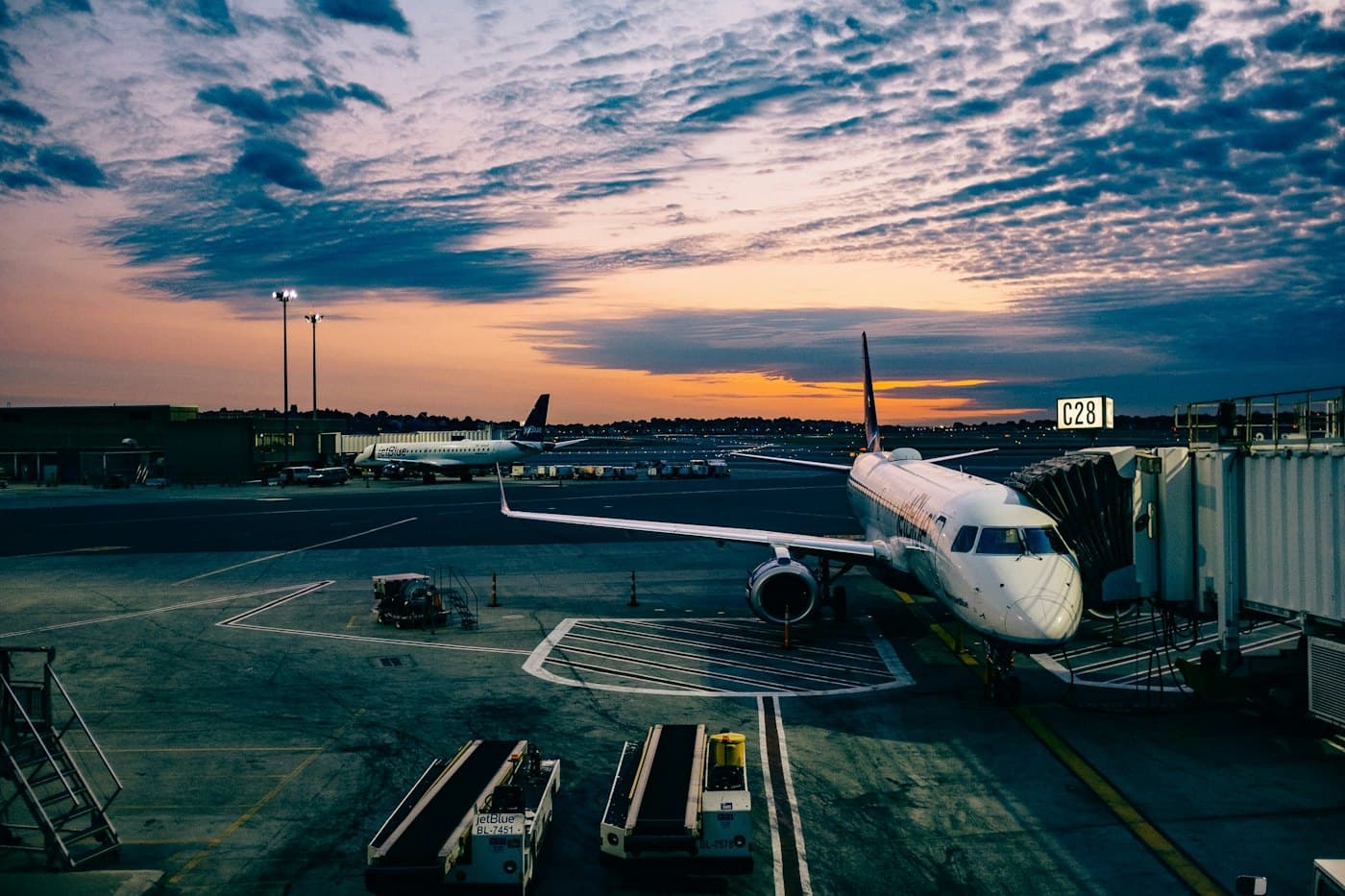 An aircraft at the gate at dusk — legal, desk-ready arrival into a named corridor.